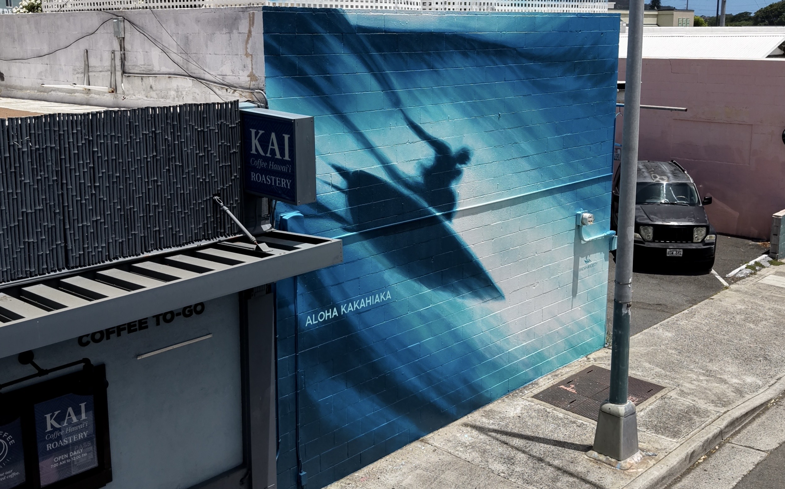 Blue surf shadow mural on Kai Coffee Roastery by Noa Hardisty